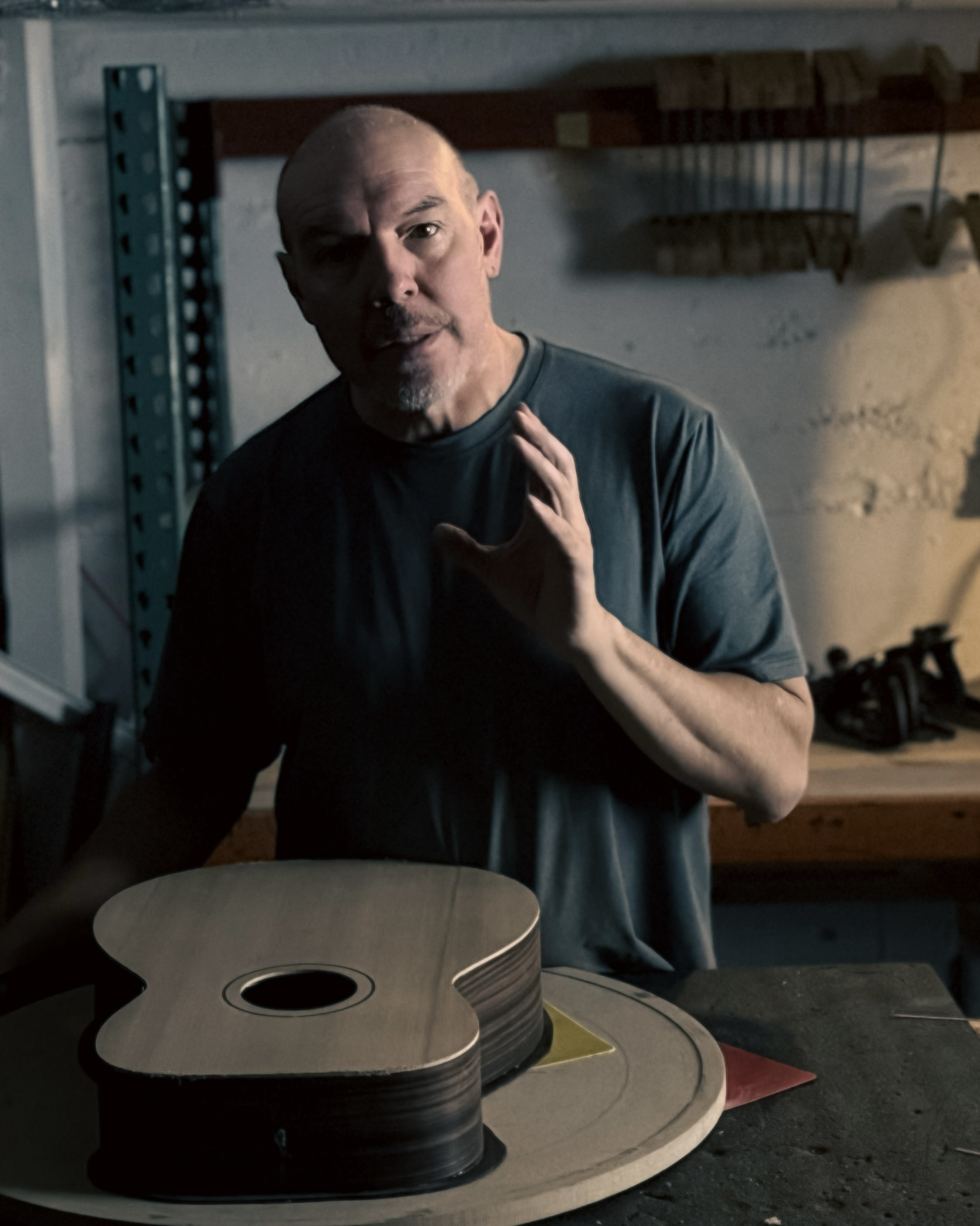 Rick Molloy in the shop with an unfinished guitar on the bench.