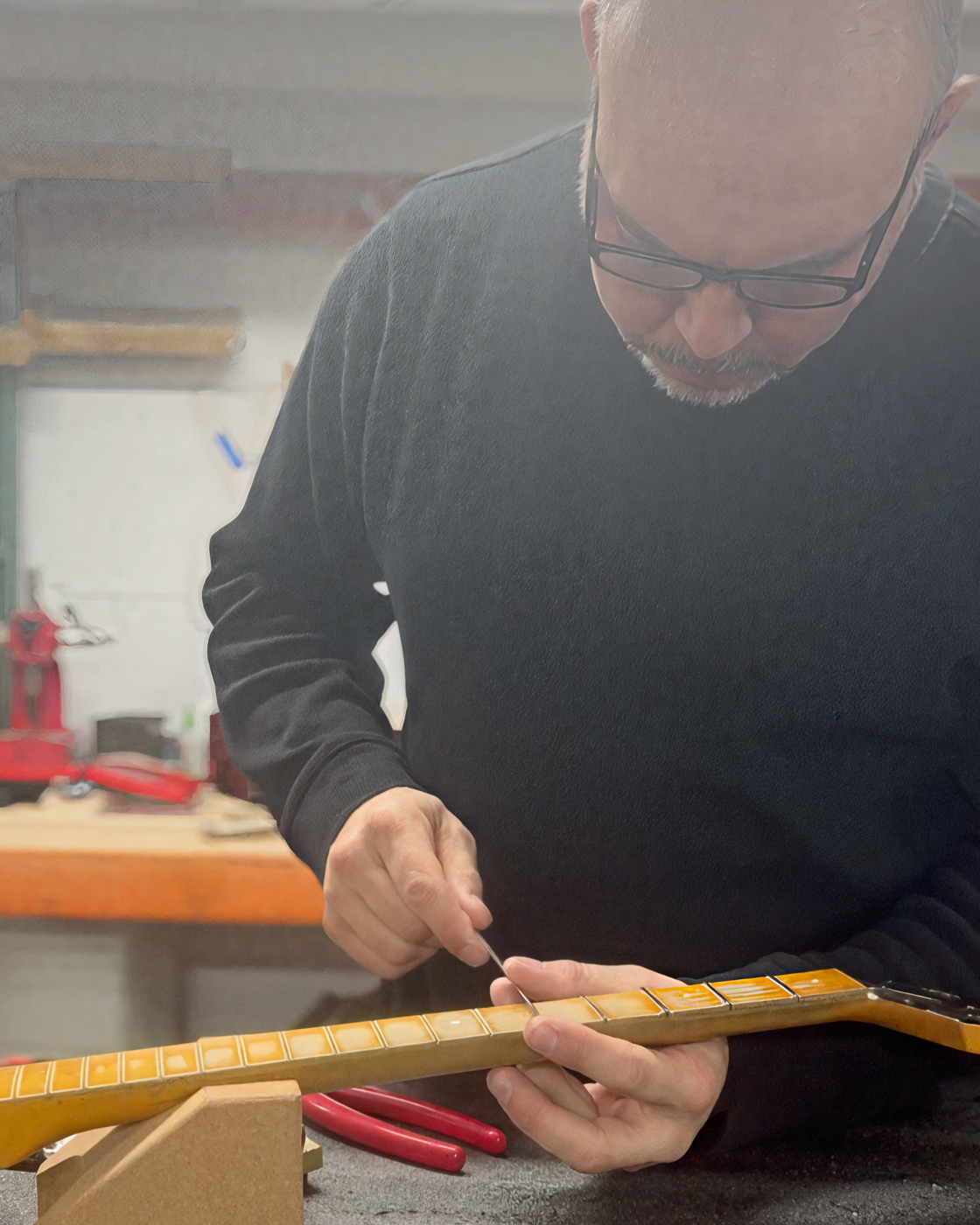 Rick Molloy working on fret detail at the bench.